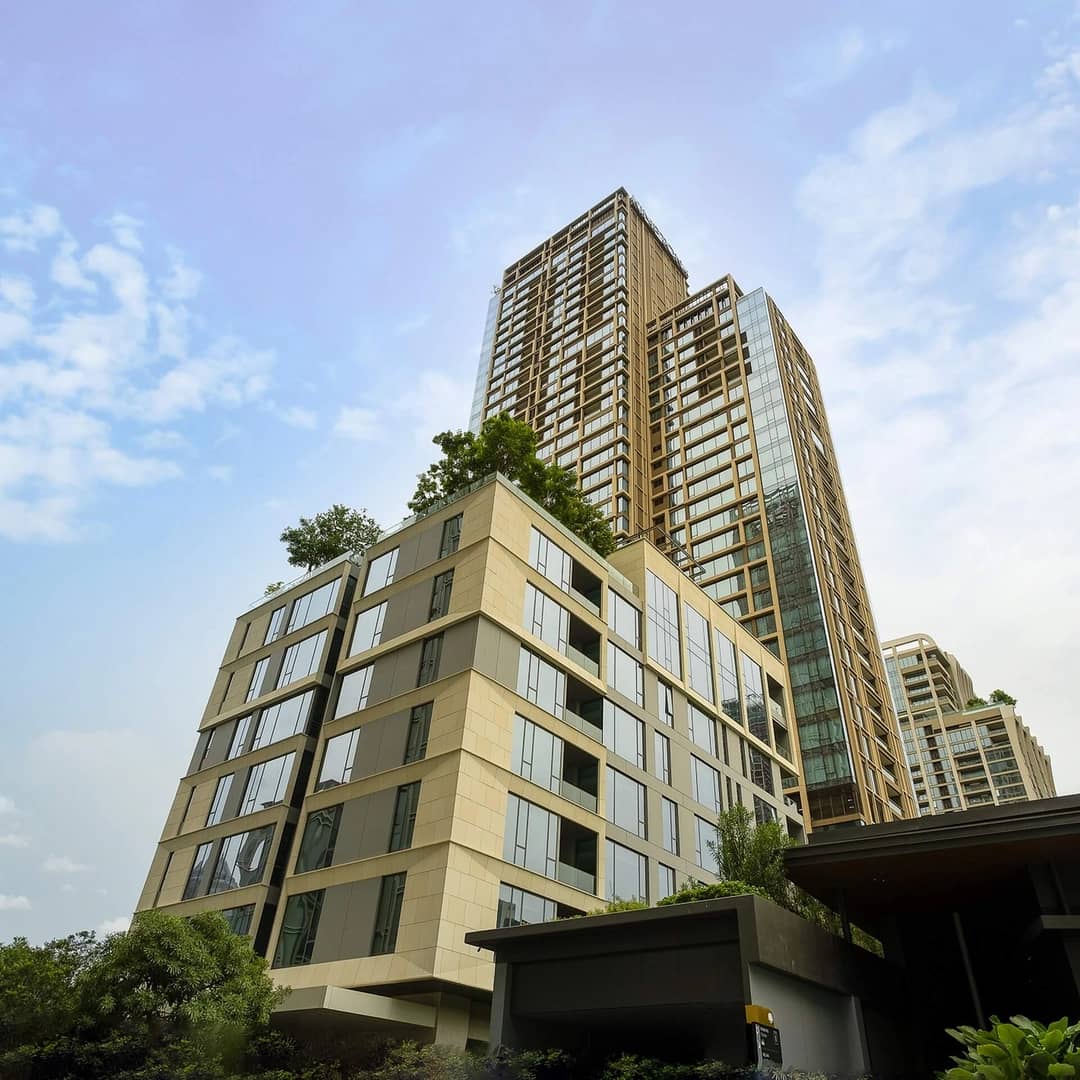 Baan Sindhorn low-rise facade in the foreground with taller neighbouring buildings behind published by Siam Sindhorn