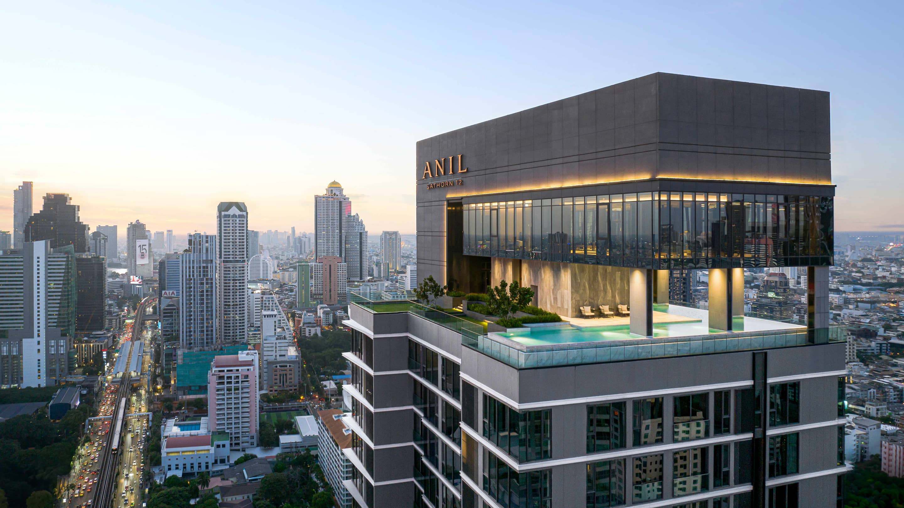 Anil Sathorn 12 tower rooftop and pool at dusk published by Grand Unity