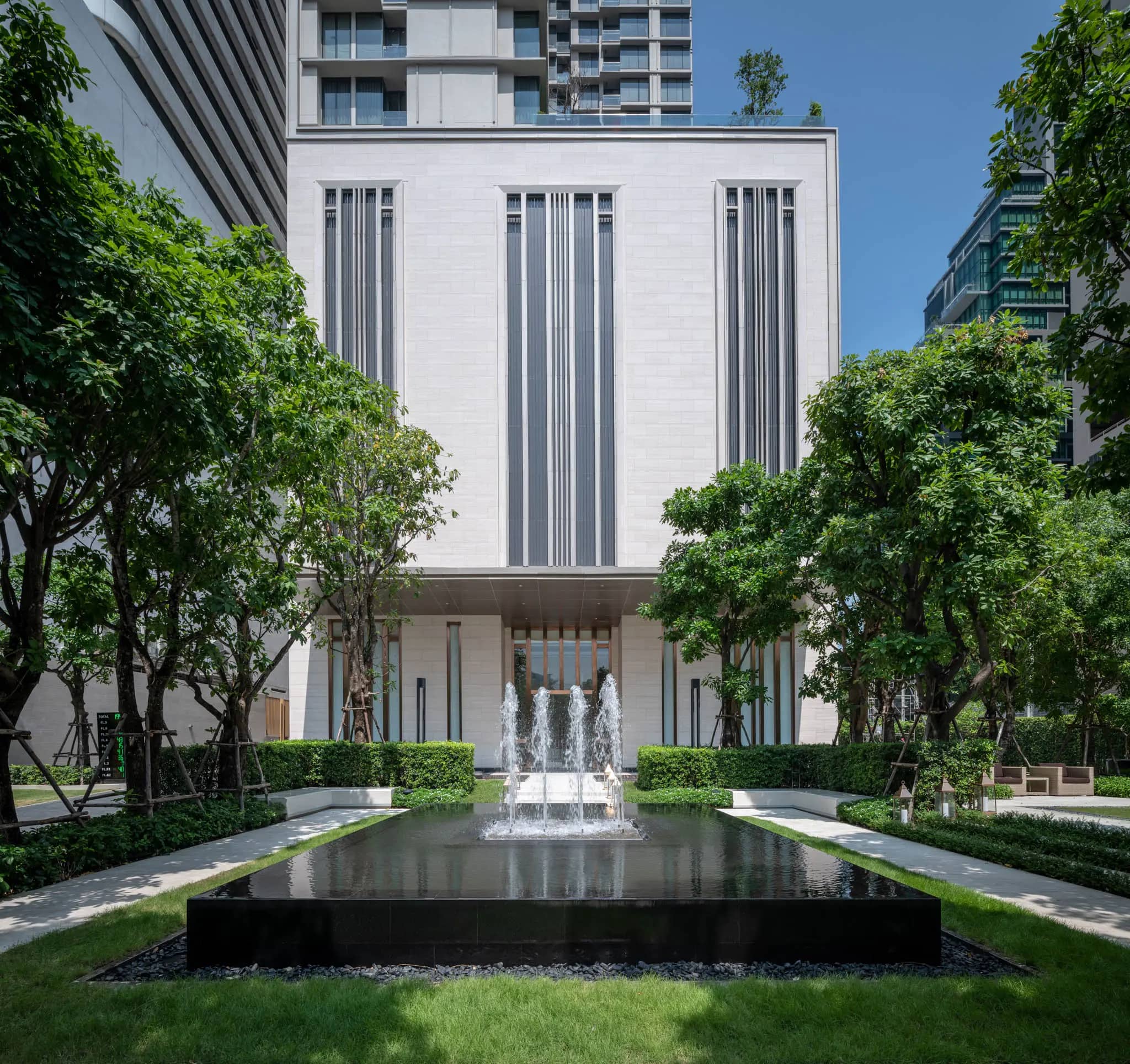 The Esse Asoke facade with front garden and reflecting pool