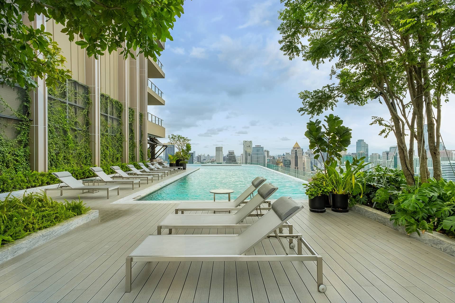 The Residences at Sindhorn Kempinski Hotel Bangkok swimming pool deck with loungers and city view