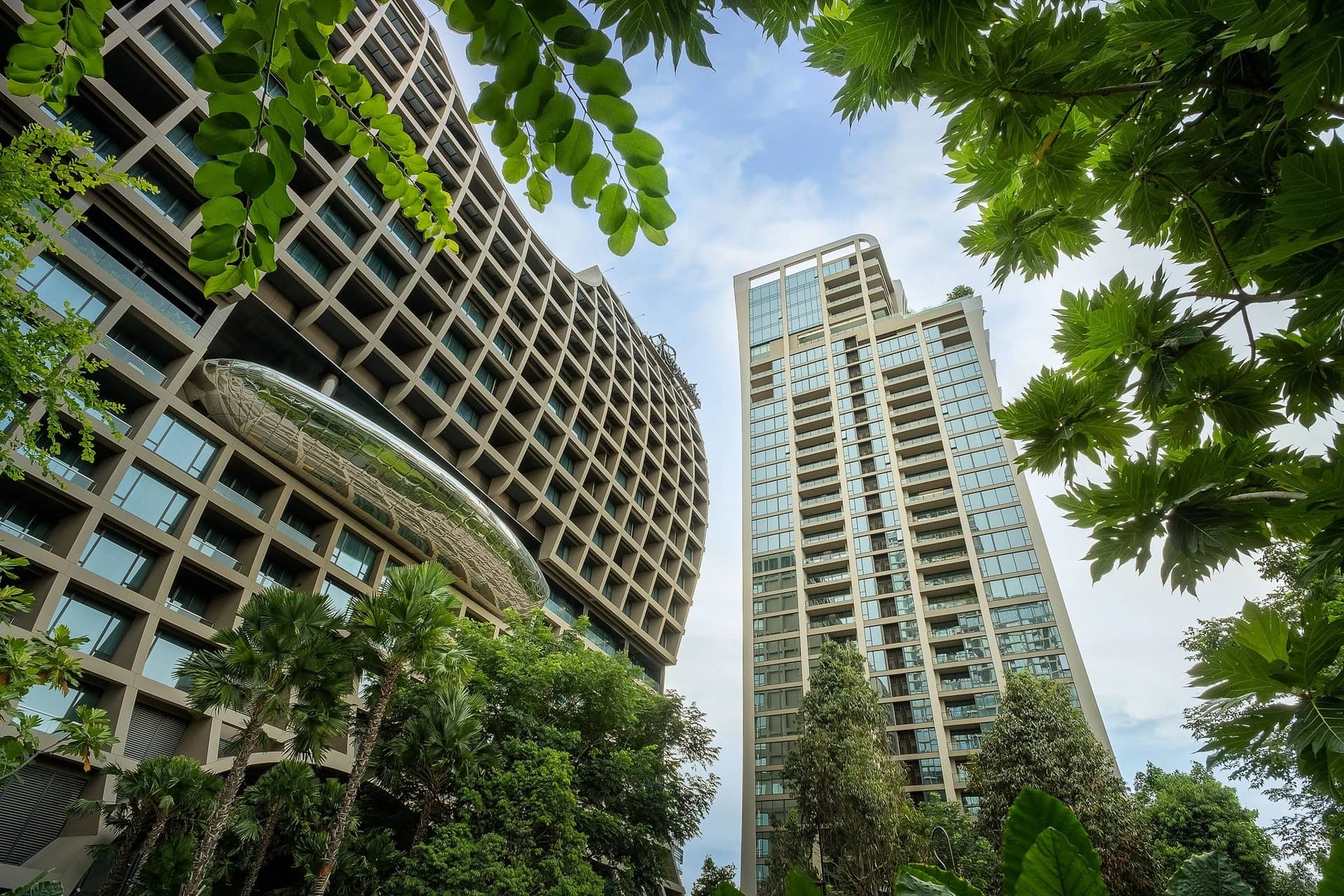 The Residences at Sindhorn Kempinski Hotel Bangkok towers seen from the garden below