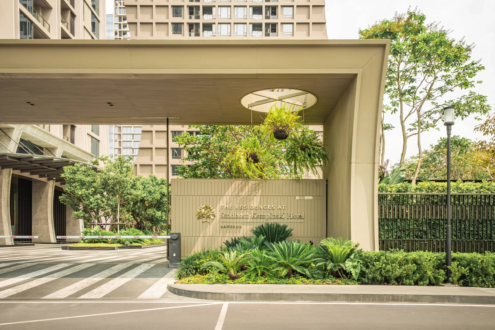 The Residences at Sindhorn Kempinski Hotel Bangkok entrance gate and driveway