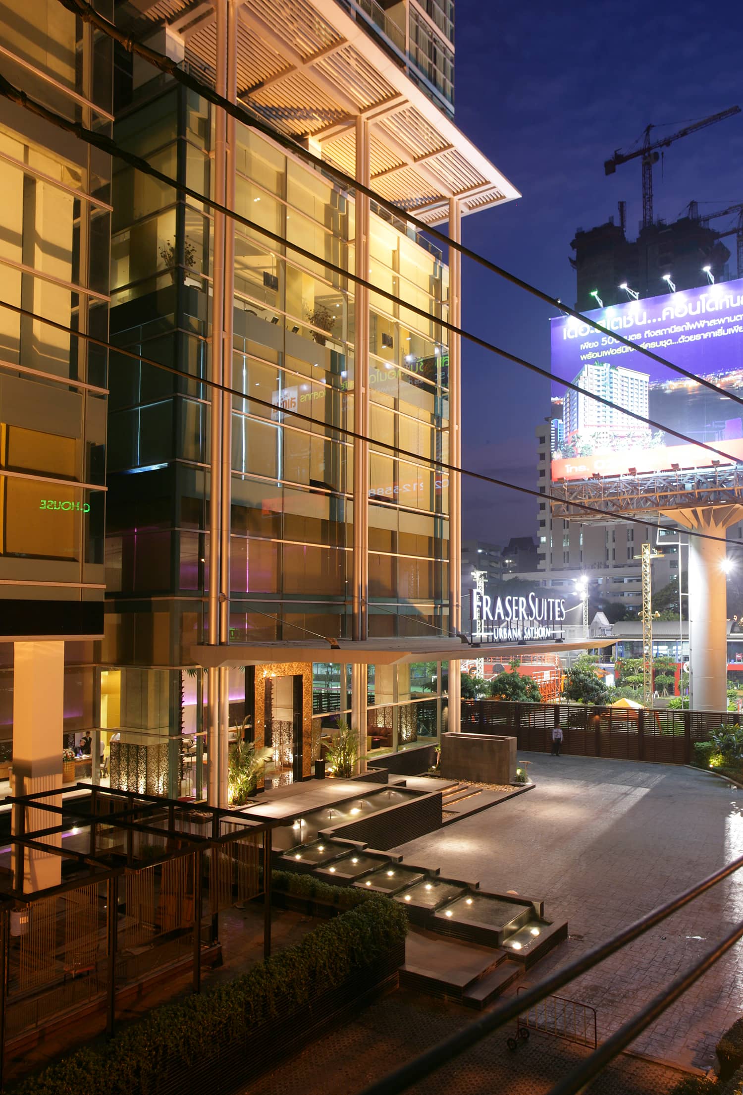 Urbana Sathorn entrance and glazed podium at dusk