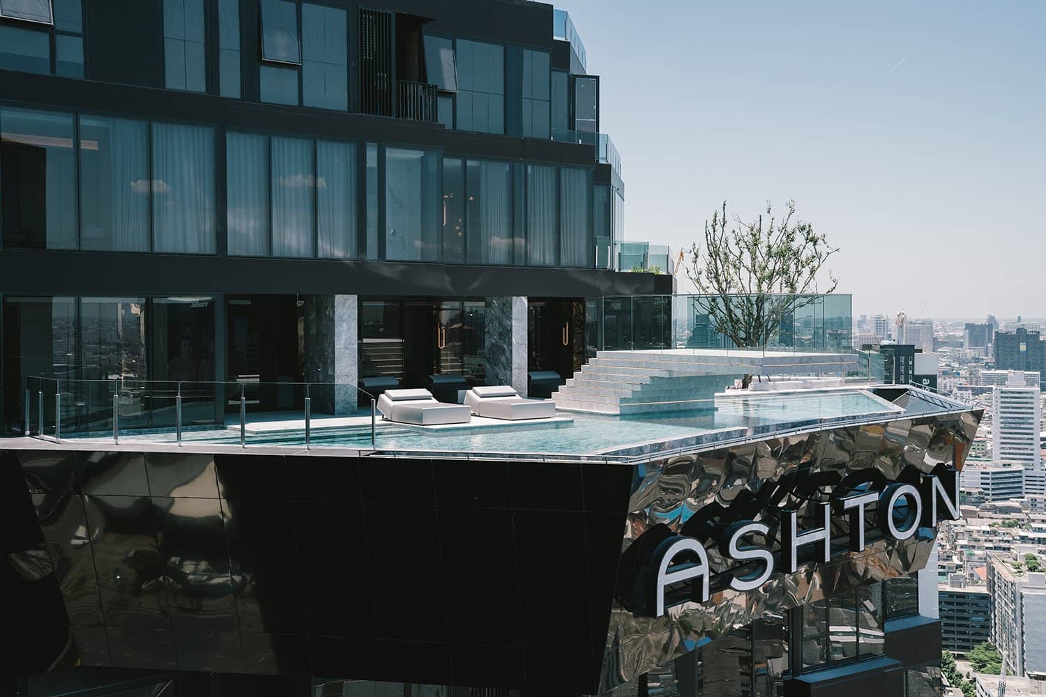 Ashton Asoke-Rama 9 rooftop infinity pool with lounge chairs and city view