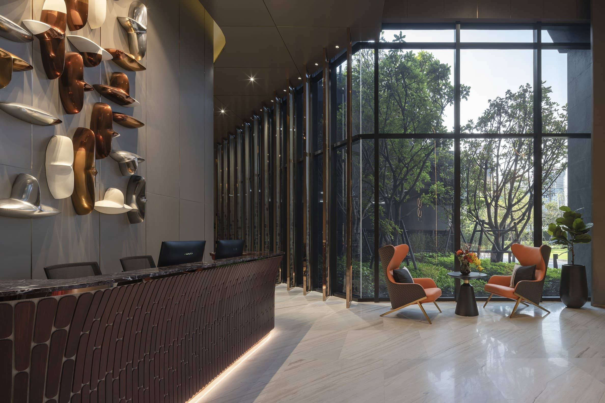 COCO Parc reception desk and garden-facing lobby published by Ananda Development