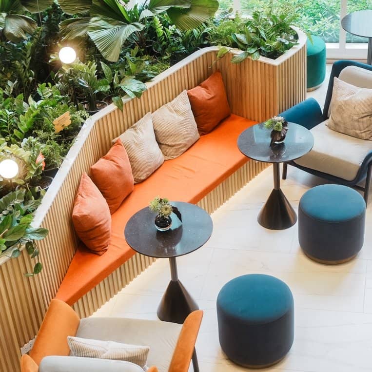 Culture Thonglor communal lounge seating beside indoor planting published by Ananda Development