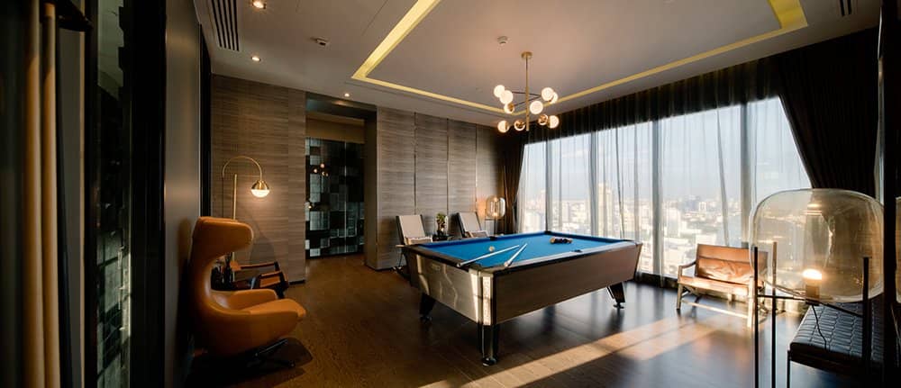Ashton Asoke billiard room with city view windows