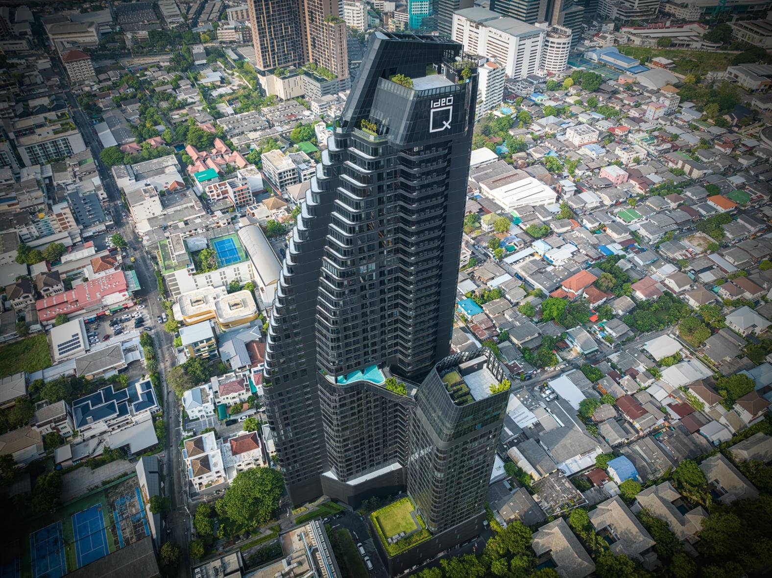 Aerial view of Ideo Q Sukhumvit 36 tower and pool terrace published by Ananda Development
