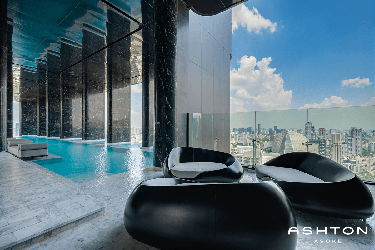 Ashton Asoke pool with black lounge chairs and sky views