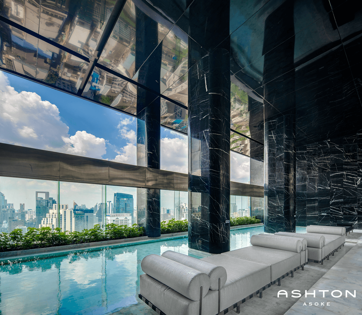 Ashton Asoke infinity pool with white loungers and Ashton logo