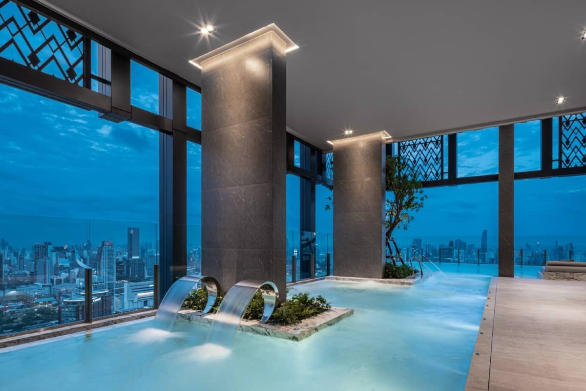 The Address Siam pool with city skyline view at blue hour