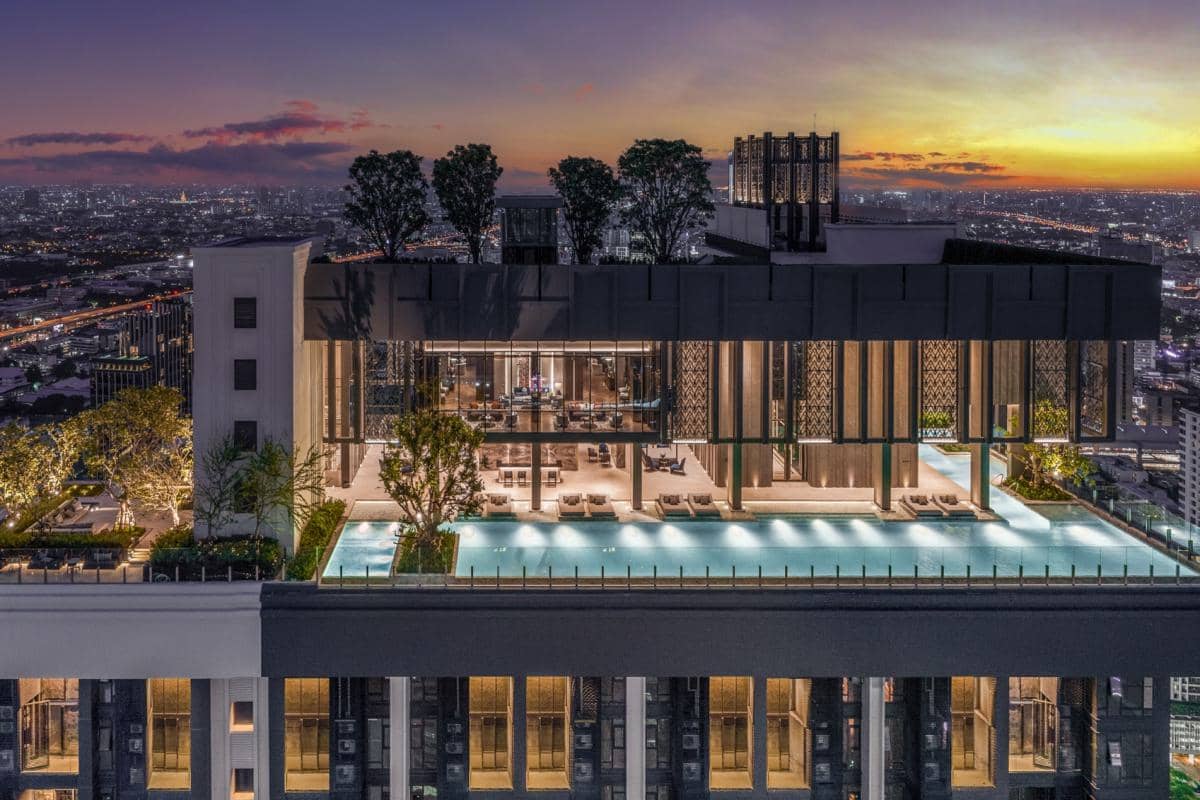 The Address Siam rooftop pool at dusk with city lights