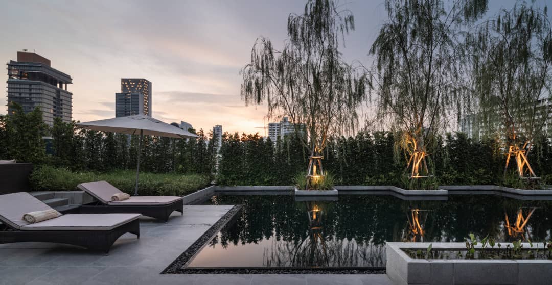 La Citta Delre Thonglor 16 pool deck with loungers at dusk