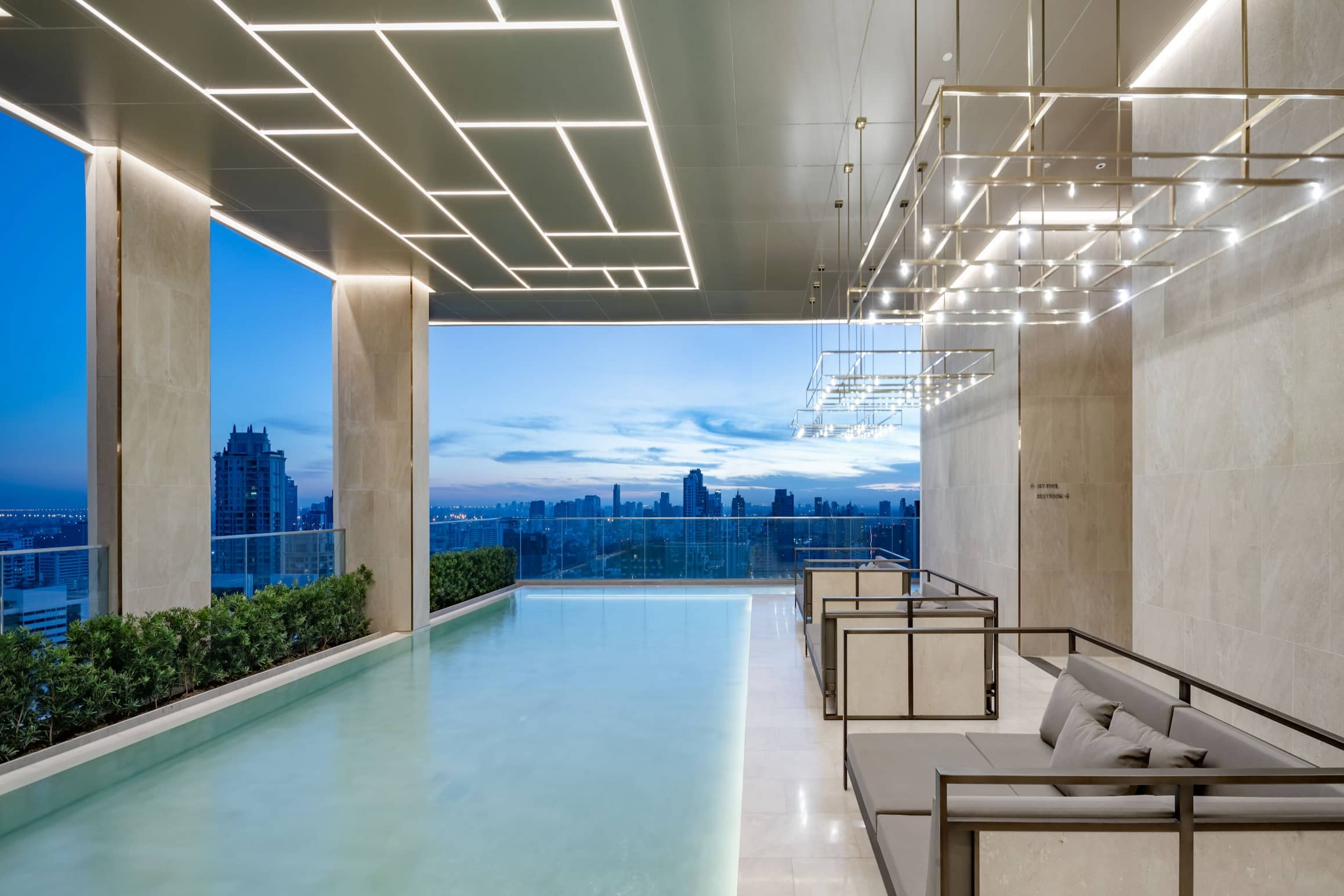 Muniq Sukhumvit 23 rooftop swimming pool at dusk
