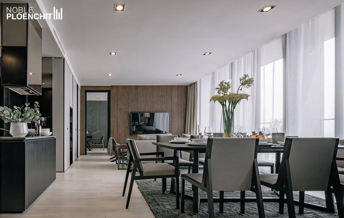Noble Ploenchit show residence open dining room with wood-panelled wall and city view