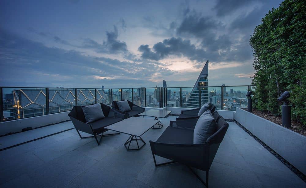Noble Ploenchit rooftop terrace lounge seating at dusk