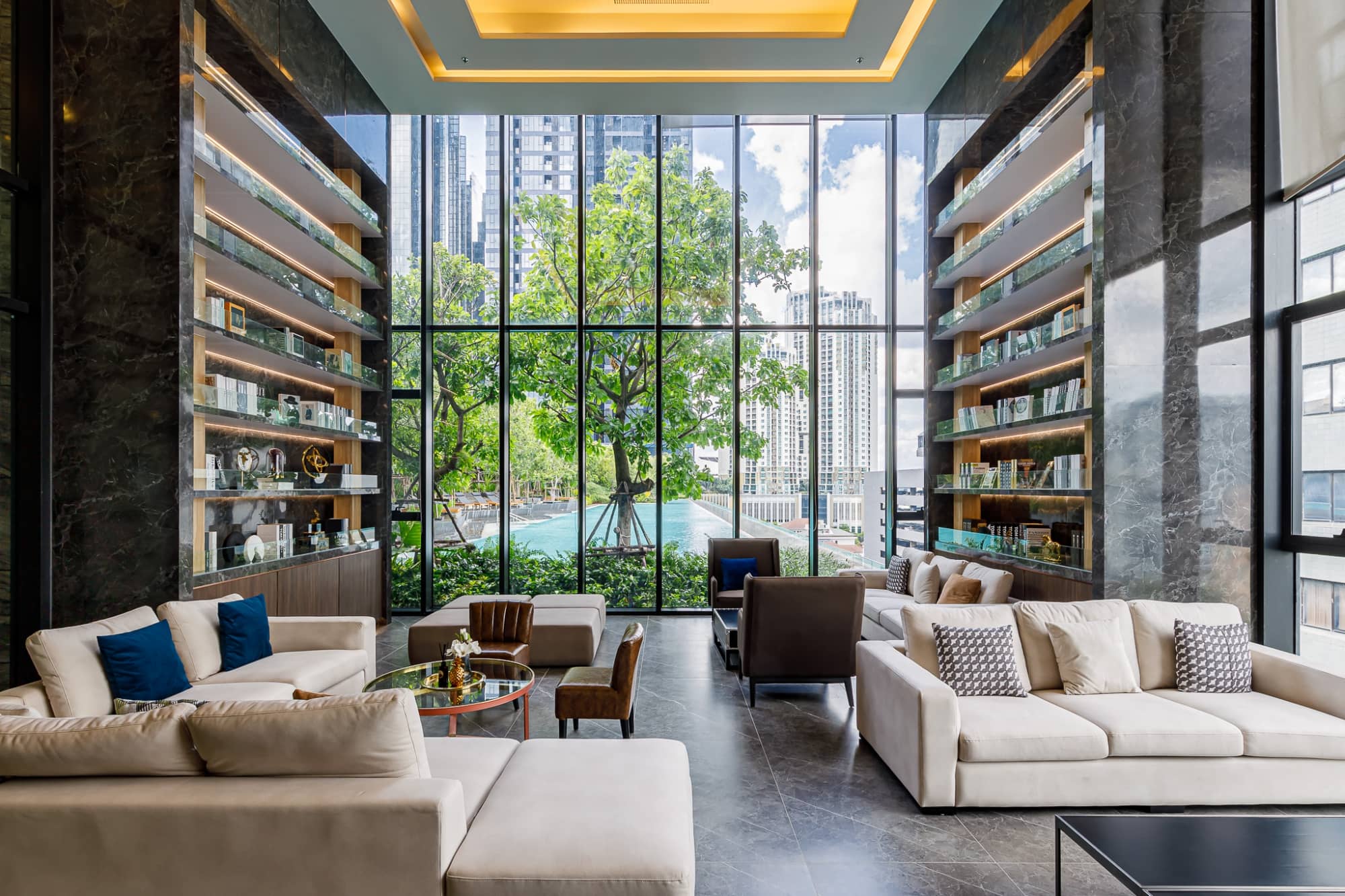 One 9 Five Asoke - Rama 9 lounge with bookshelves and garden view