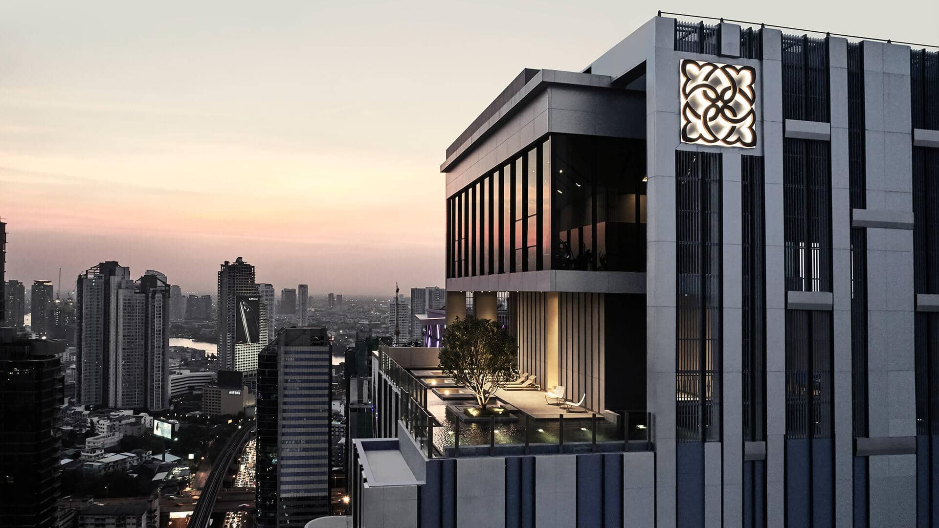 The Diplomat Sathorn upper floors and rooftop terrace at dusk