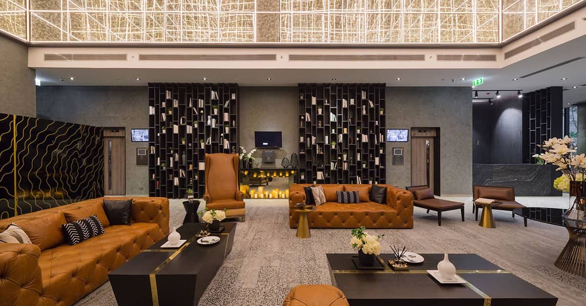 The Lofts Asoke lobby lounge with leather sofas and fireplace