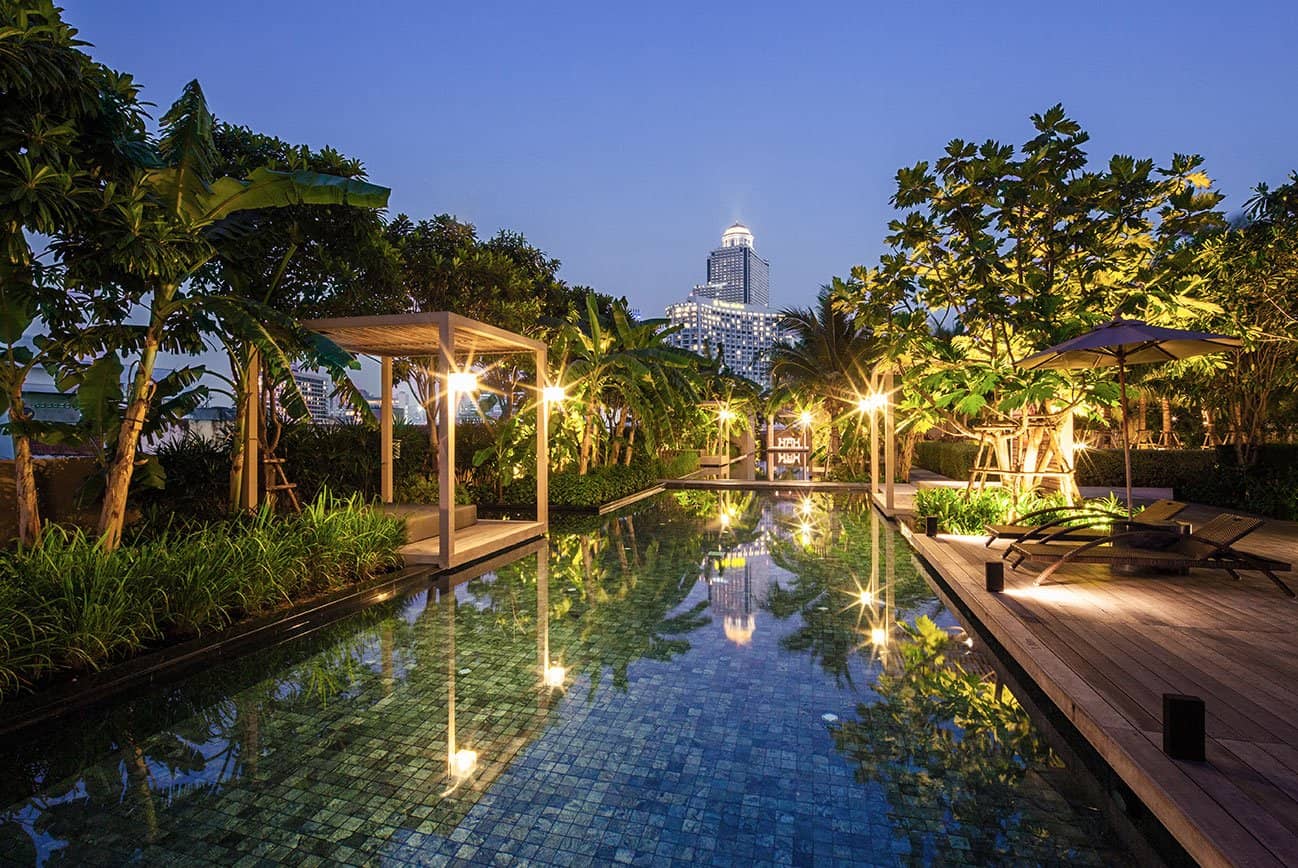 Landscaped pool deck at dusk