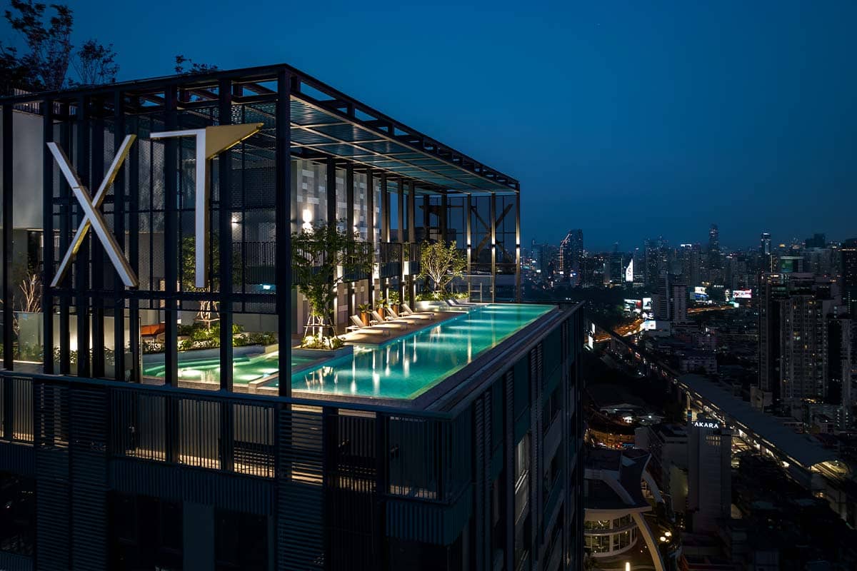 XT Phayathai rooftop pool at night with city lights