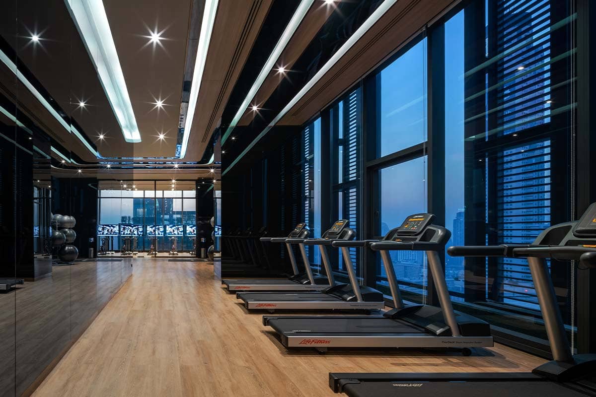 XT Phayathai fitness room with treadmills and city views