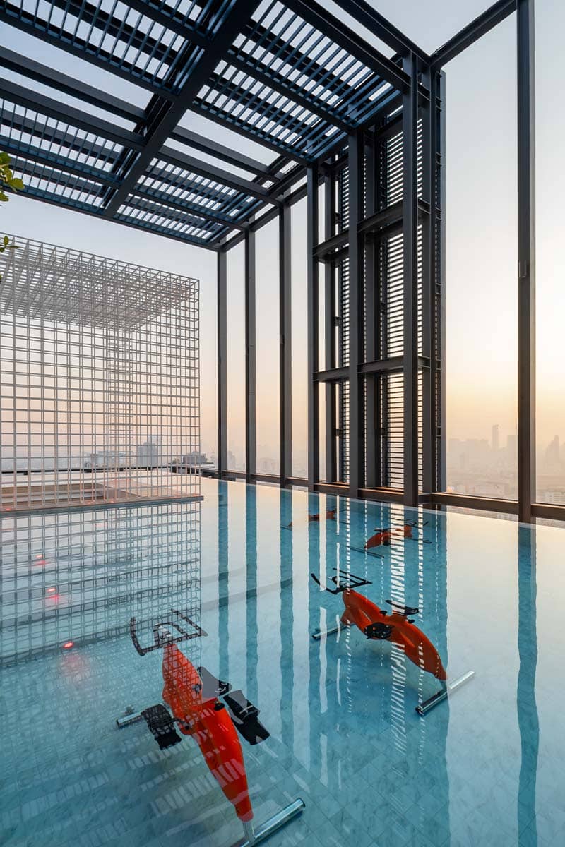 XT Phayathai pool under a pergola with glass walls และ floats