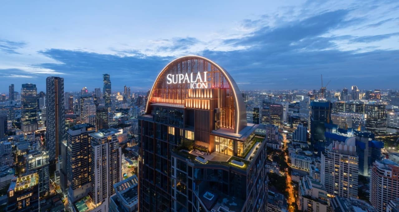 Supalai Icon Sathorn crown at dusk over the Sathorn skyline
