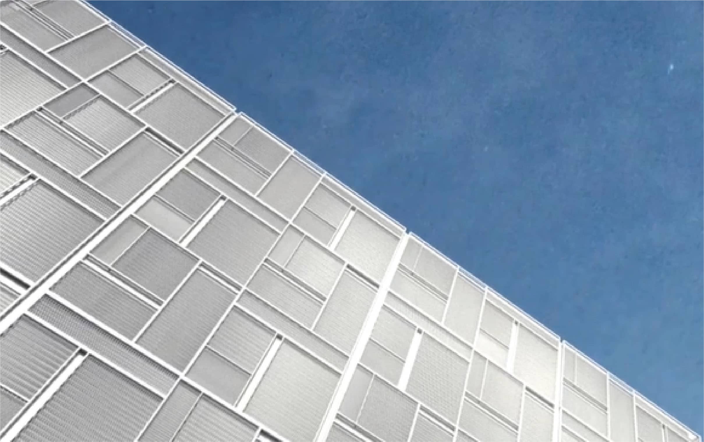 Tela Thonglor white facade panels against blue sky