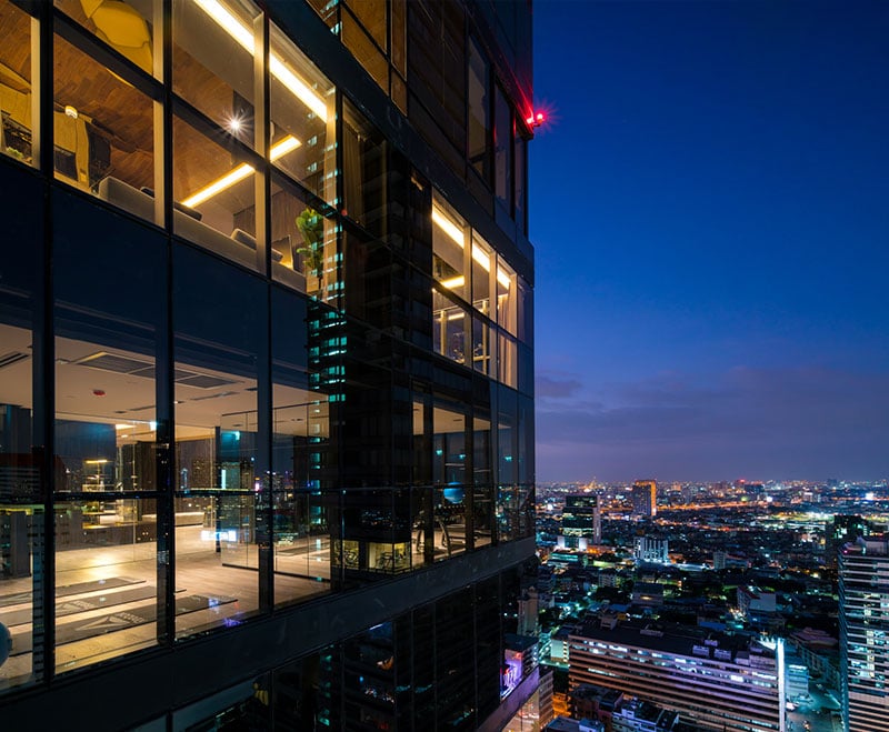 Ashton Silom glass facade at dusk