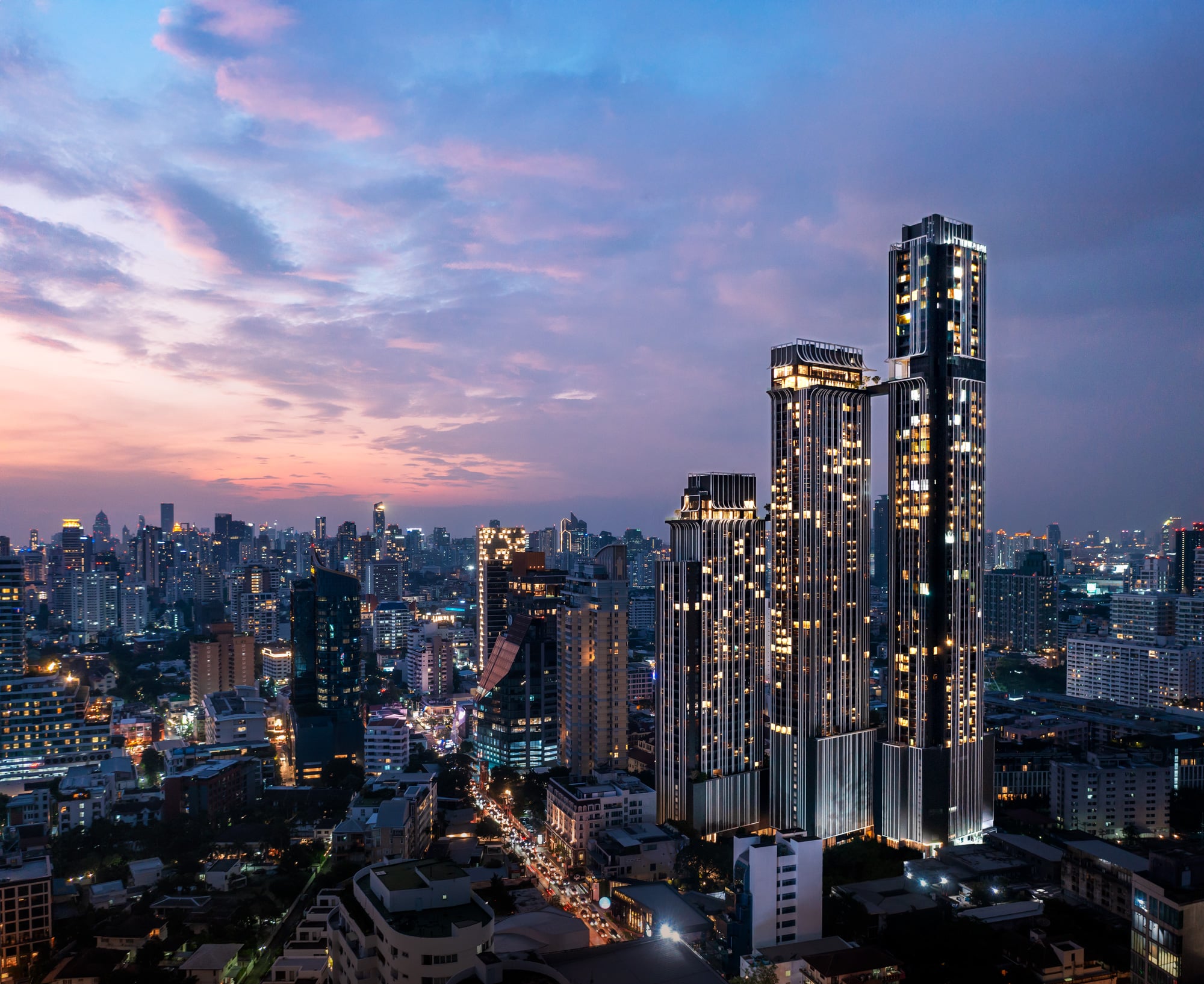 Park Origin Thonglor tower at dusk against the Bangkok skyline