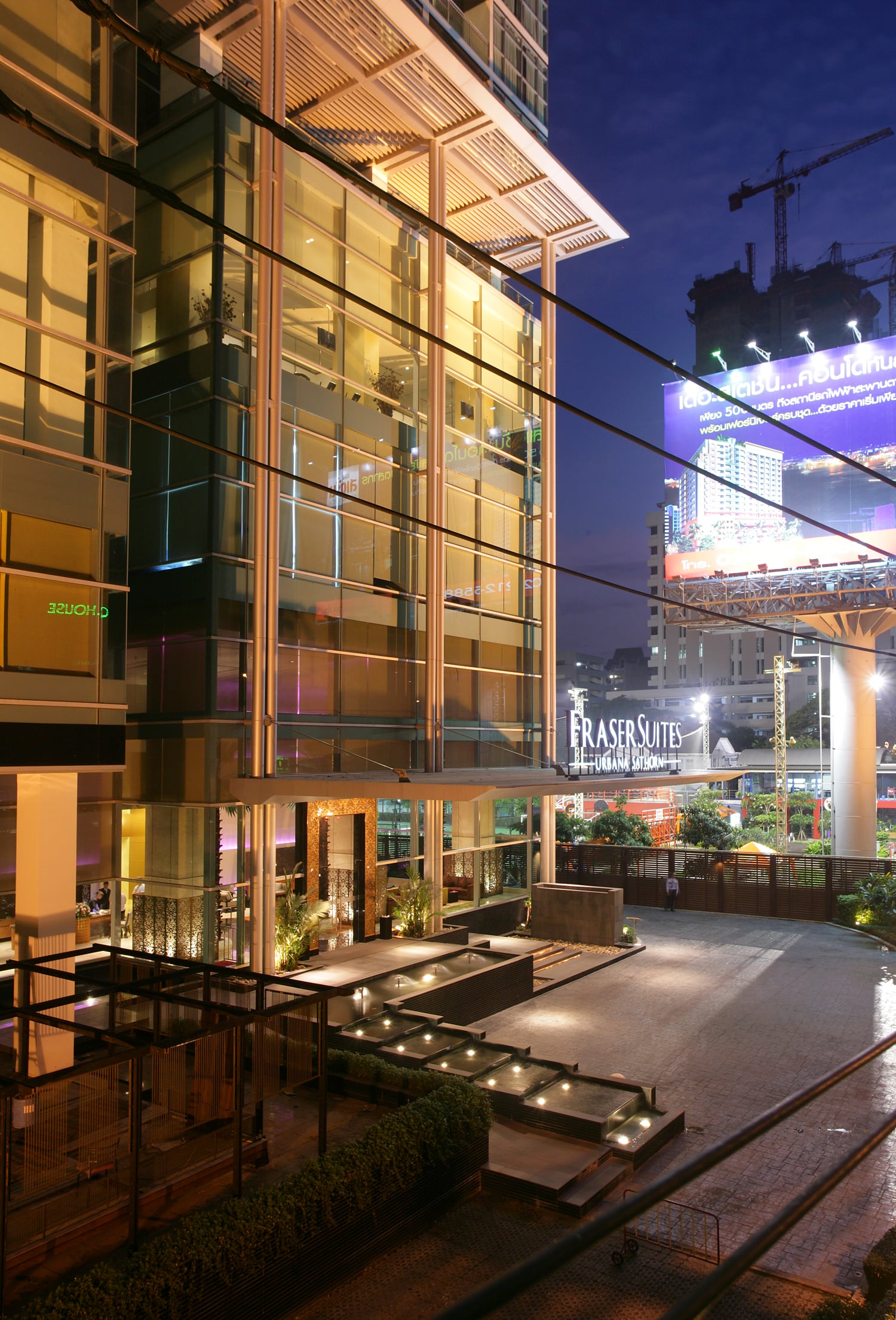 Urbana Sathorn entrance and glazed podium at dusk