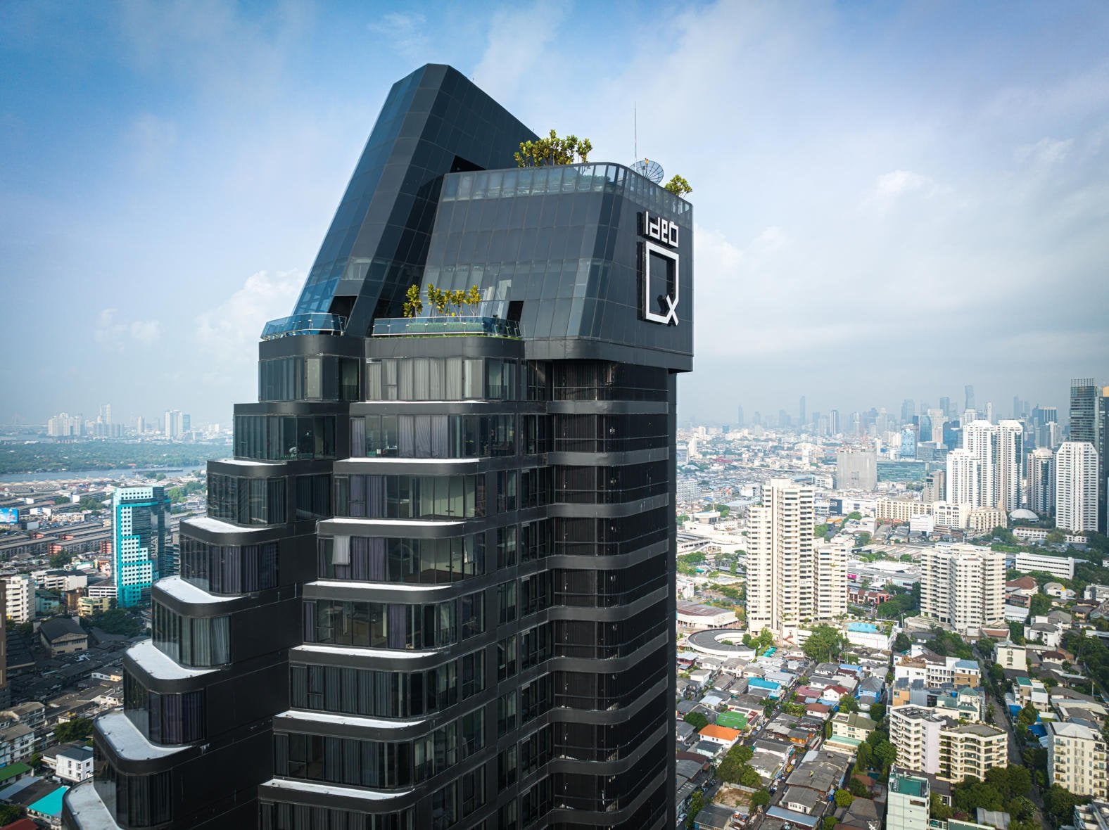 Ideo Q Sukhumvit 36 tower exterior and rooftop greenery published by Ananda Development