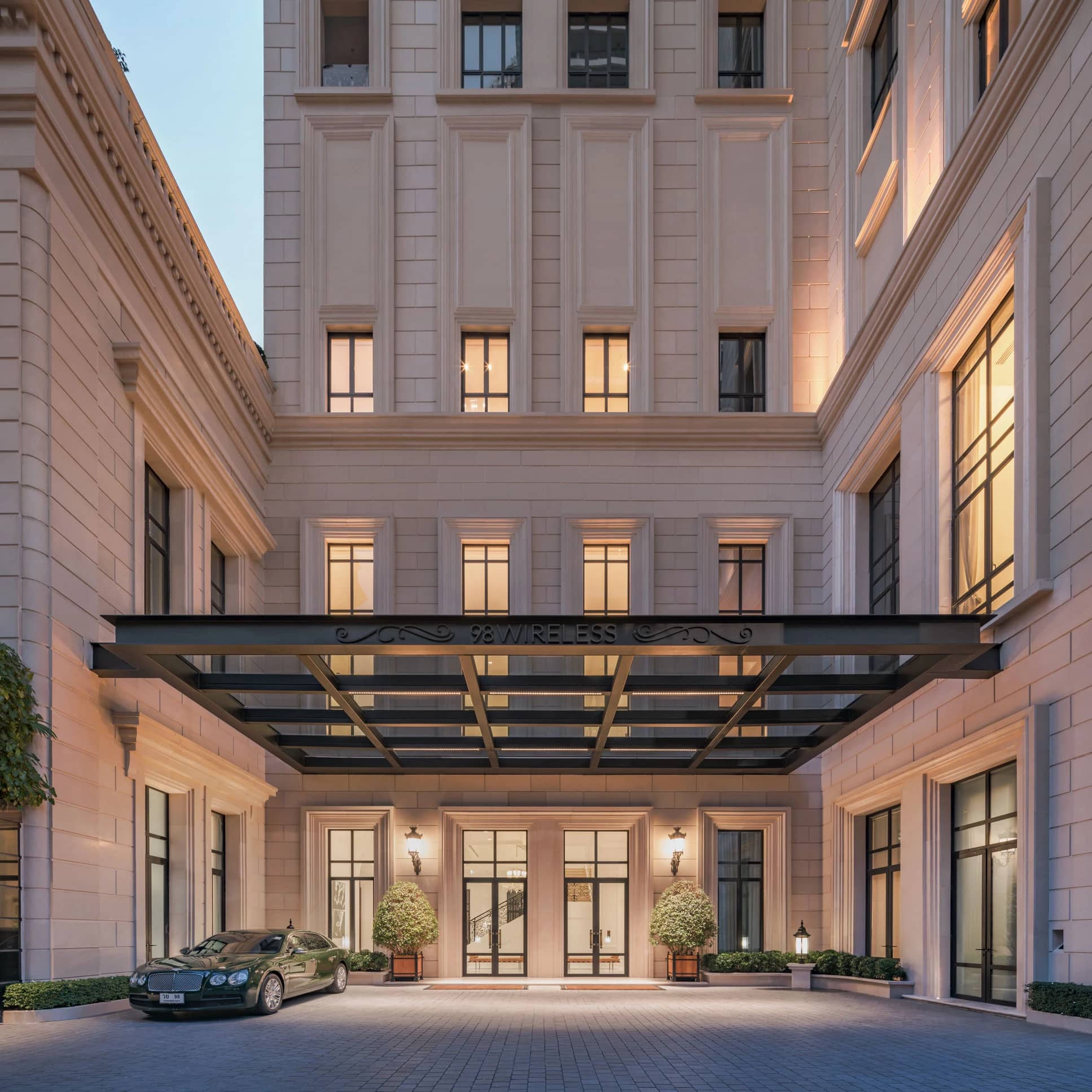 98 Wireless entrance courtyard and limestone facade at dusk