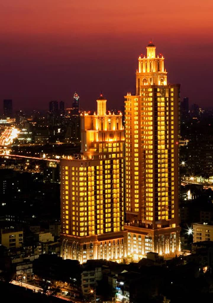 Aguston Sukhumvit 22 twin towers illuminated at dusk